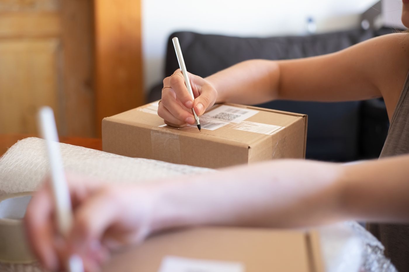 Photograph: hands labeling a box for shipping