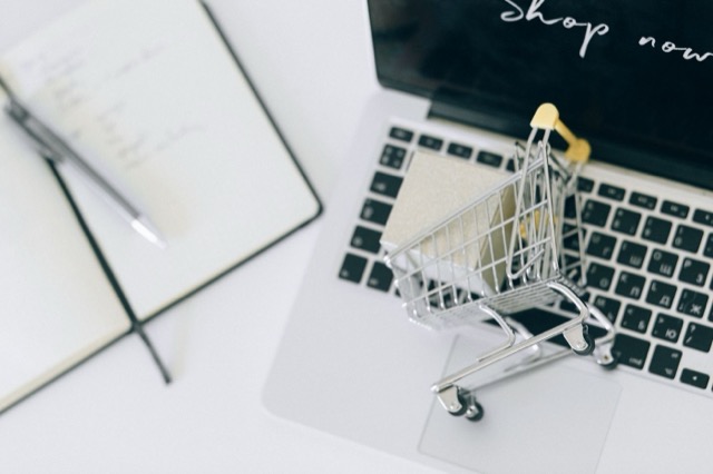 Photograph: miniature shopping cart on a laptop