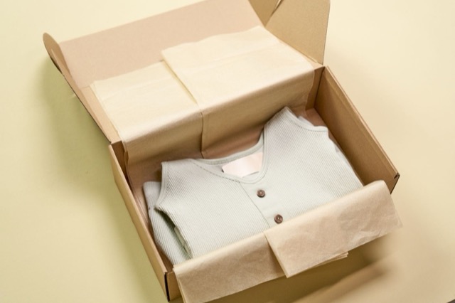 Photograph: garment packed in recyclable paper, subscription box