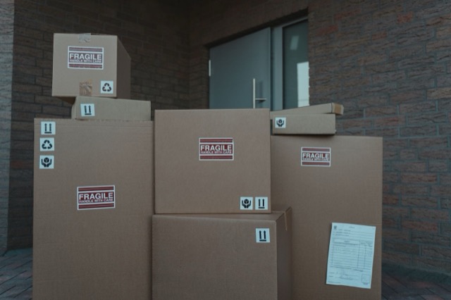 Photograph: stack of fragile-marked parcels at an entrance