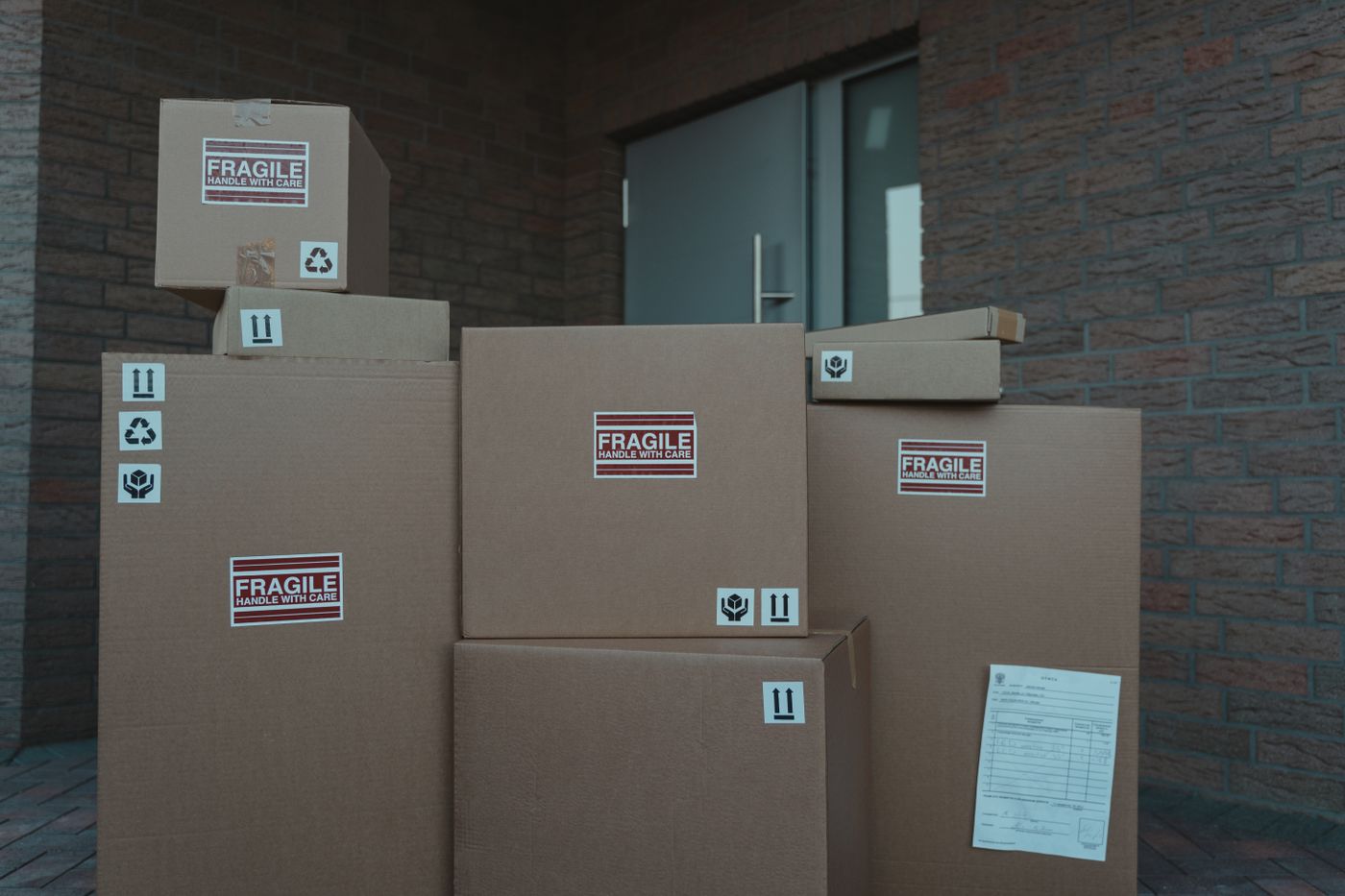 Photograph: stack of fragile-marked parcels at an entrance